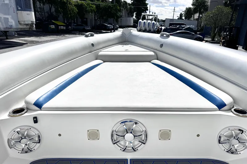 Slide: The Image of Airship 330 boat interior, 2014 model, featuring white and blue seating with speakers. - 12