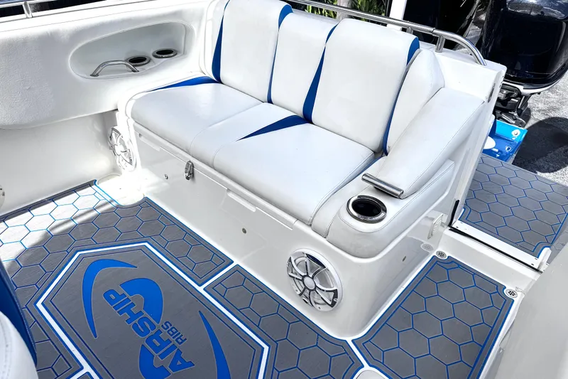 Slide: The Image of Interior of 2014 Airship 330 boat with white seating and hexagonal patterned flooring. - 6