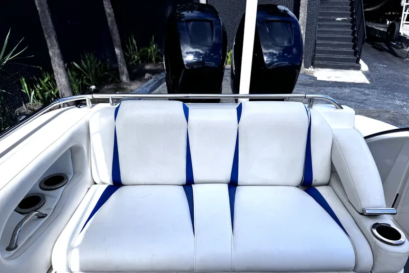 Slide: The Image of White and blue boat seating on 2014 Airship 330, with dual outboard motors in background. - 7