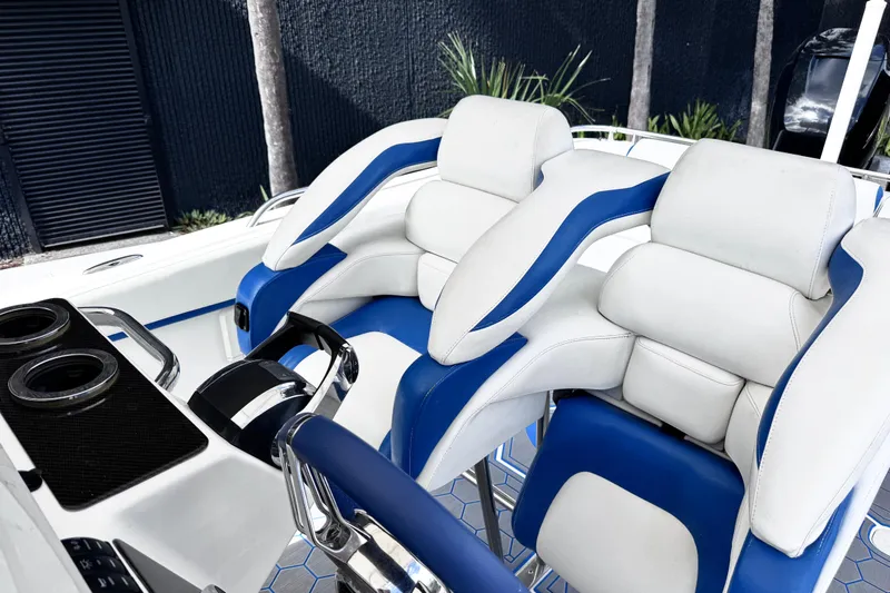 Slide: The Image of Luxury seating on a 2014 Airship 330 boat, featuring white and blue cushioned seats. - 9