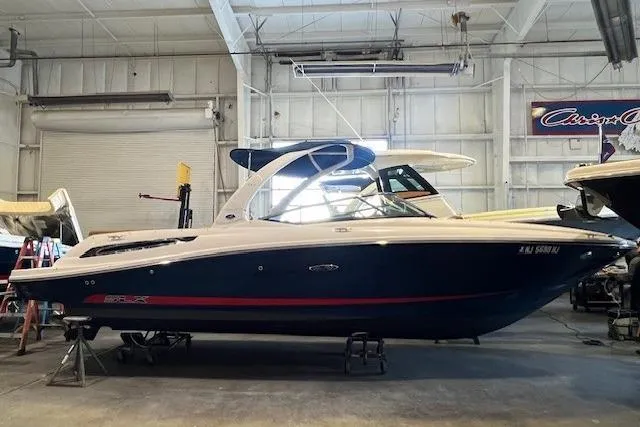The Image of 2016 Sea Ray 250 SLX boat in a warehouse, side view. - 0