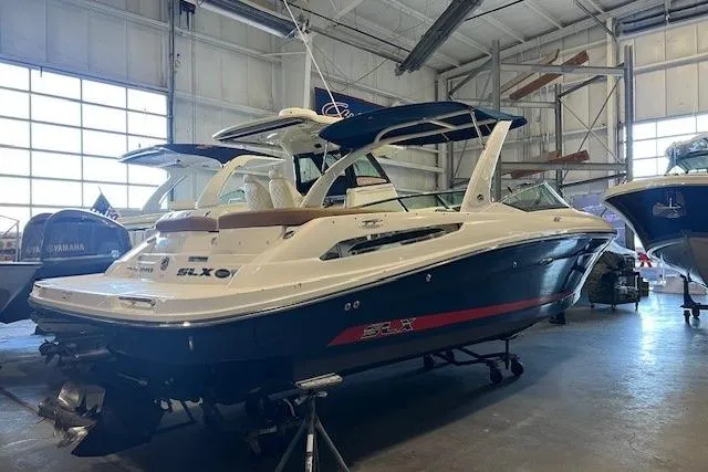 Slide: The Image of 2016 Sea Ray 250 SLX boat in a warehouse, showcasing sleek design and luxury features. - 1