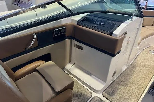 Slide: The Image of Interior of 2016 Sea Ray 250 SLX boat with tan seating and modern dashboard. - 13