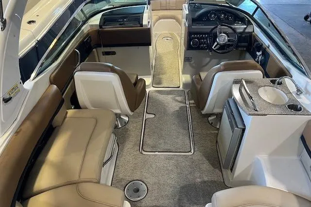 Slide: The Image of Interior of 2016 Sea Ray 250 SLX boat with beige seating and modern dashboard. - 15