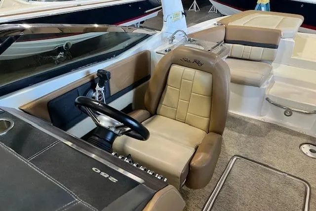 Slide: The Image of 2016 Sea Ray 250 SLX boat interior with tan leather seating and steering wheel. - 19