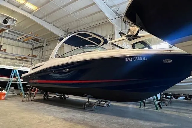 Slide: The Image of 2016 Sea Ray 250 SLX boat in indoor storage facility. - 2