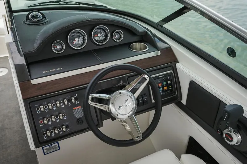 Slide: The Image of Manufacturer Provided Image: 2015 Sea Ray 250 SLX boat dashboard with steering wheel and control panel. - 30