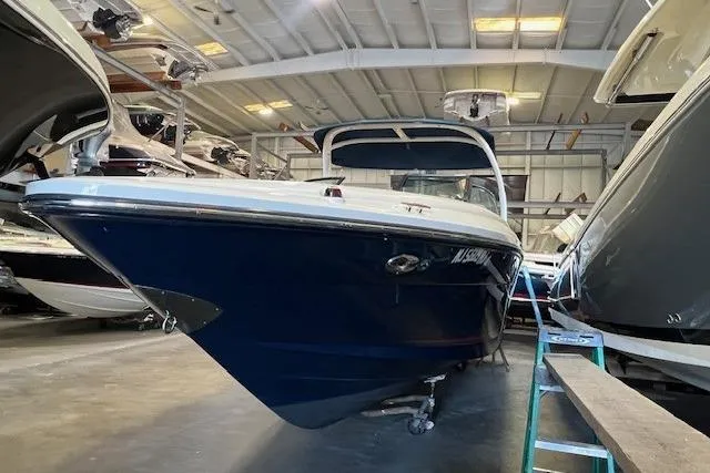 Slide: The Image of 2016 Sea Ray 250 SLX boat in indoor storage, blue hull, well-maintained condition. - 4