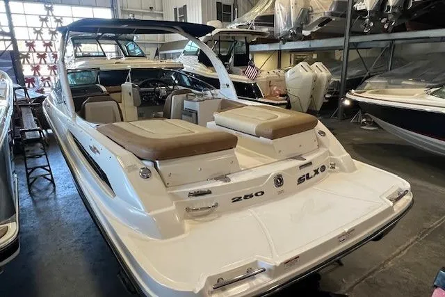 Slide: The Image of 2016 Sea Ray 250 SLX boat in showroom, featuring sleek design and comfortable seating. - 6