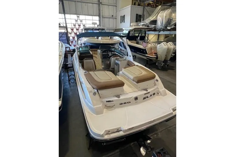Slide: The Image of 2016 Sea Ray 250 SLX boat in indoor storage, showcasing sleek design and comfortable seating. - 7