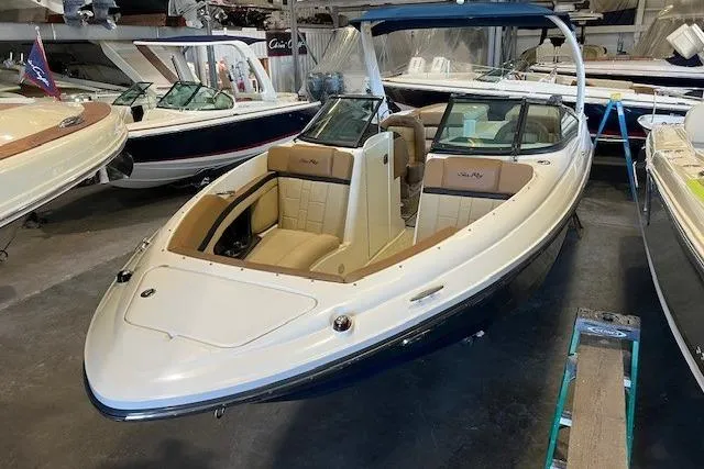 Slide: The Image of 2016 Sea Ray 250 SLX boat in showroom, featuring sleek design and luxurious seating. - 8