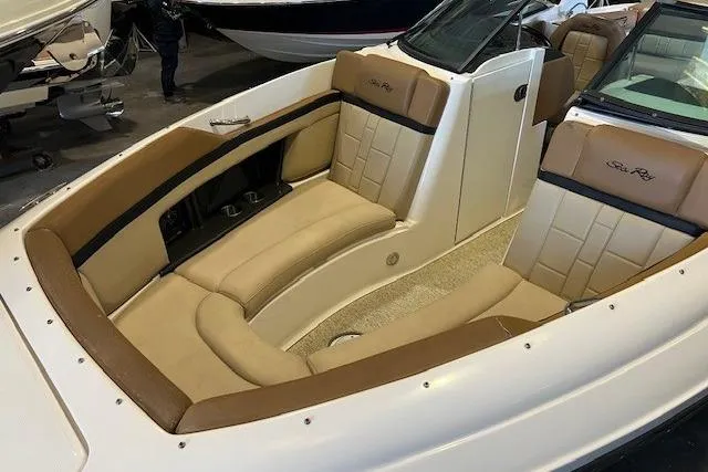 Slide: The Image of 2016 Sea Ray 250 SLX boat interior with tan leather seating and sleek design. - 9