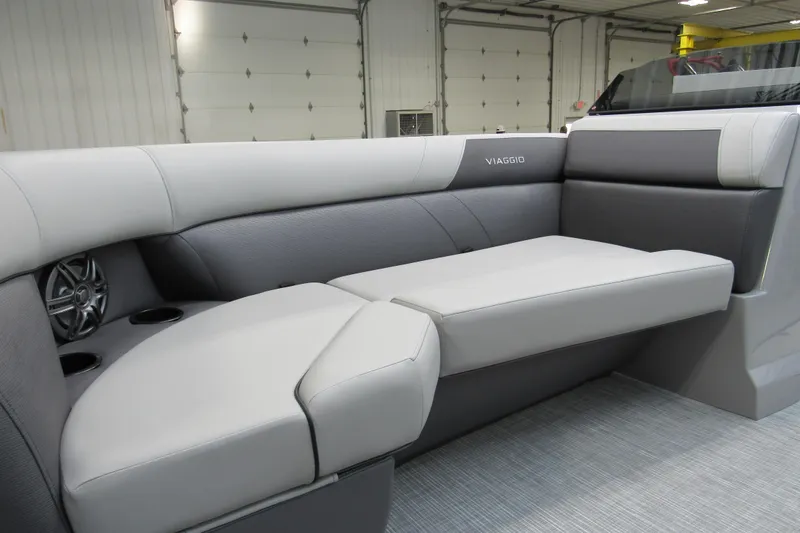 Slide: The Image of 2026 Viaggio Lago V22U boat interior with sleek gray seating and integrated speakers. - 17