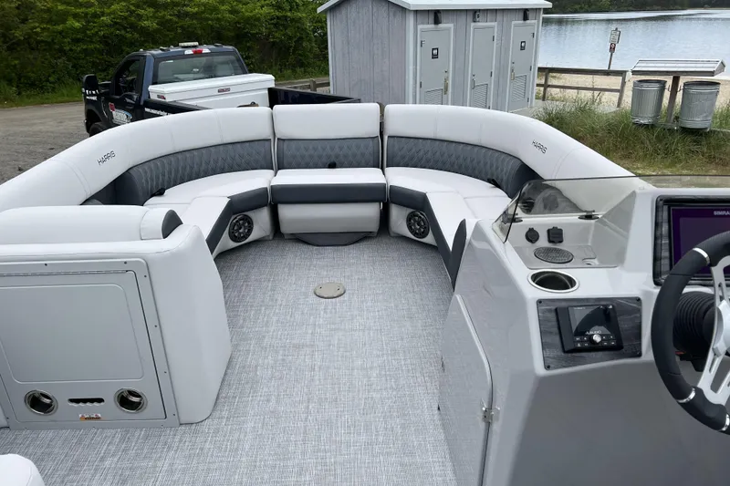 Slide: The Image of 2021 Harris FloteBote Sunliner 230 pontoon boat interior with plush seating and modern dashboard. - 4