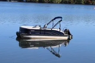Slide: The Image of 2021 Harris FloteBote Sunliner 230 pontoon boat on calm lake water. - 7