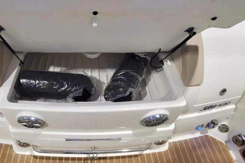 Slide: The Image of 2017 Formula 350 Crossover Bowrider storage compartment with wrapped items inside. - 14