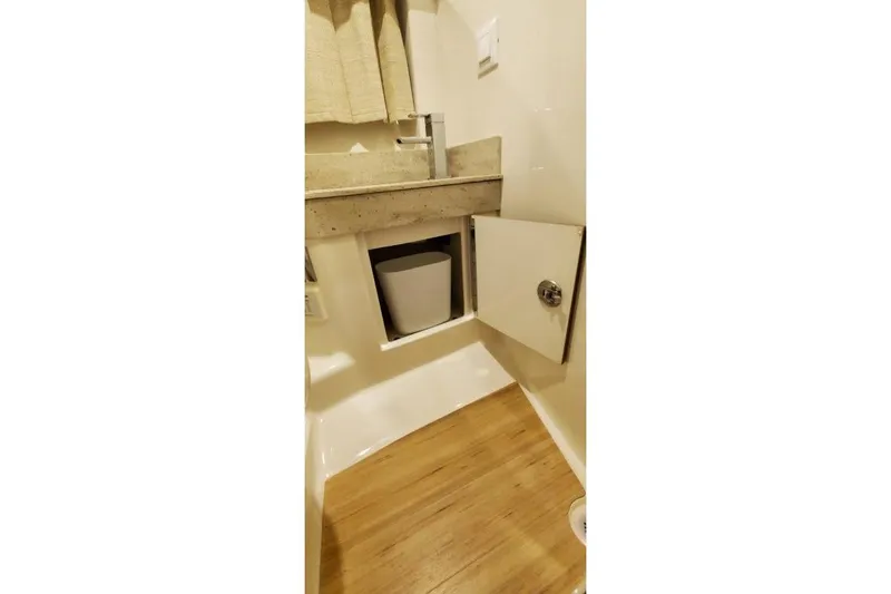 Slide: The Image of 2017 Formula 350 Crossover Bowrider bathroom with open cabinet and modern sink. - 23