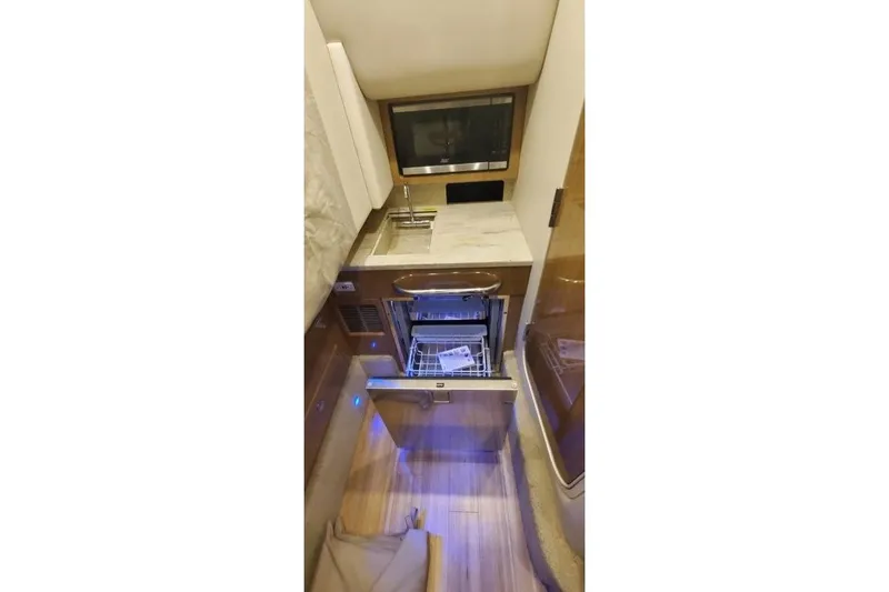Slide: The Image of Interior of 2017 Formula 350 Crossover Bowrider featuring a compact kitchenette. - 24
