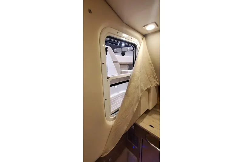 Slide: The Image of Interior view of 2017 Formula 350 Crossover Bowrider cabin window with curtain. - 25