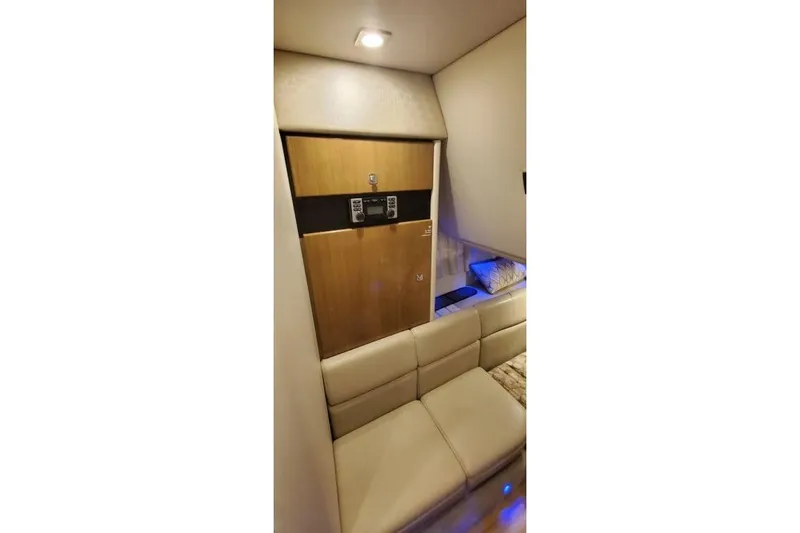 Slide: The Image of 2017 Formula 350 Crossover Bowrider interior with beige seating and wooden cabinetry. - 26