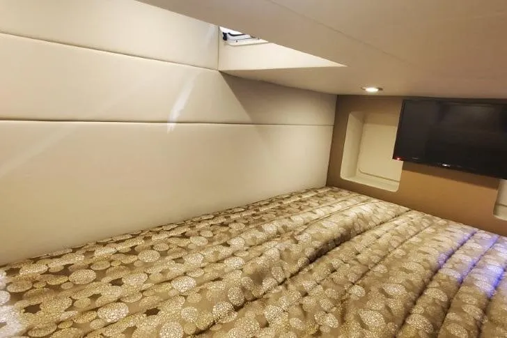 Slide: The Image of 2017 Formula 350 Crossover Bowrider cabin with bed and TV, featuring modern interior design. - 29