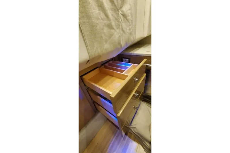 Slide: The Image of Open wooden drawer in 2017 Formula 350 Crossover Bowrider, showcasing interior storage space. - 32