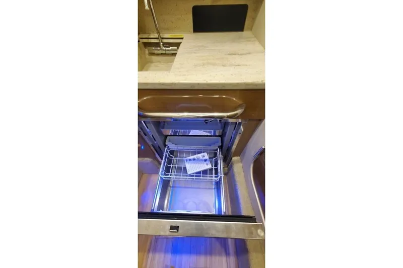 Slide: The Image of 2017 Formula 350 Crossover Bowrider interior with open drawer and blue lighting. - 36