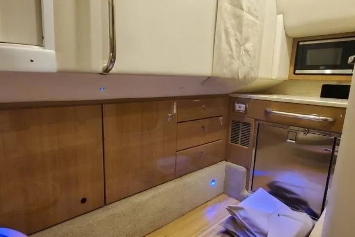 Slide: The Image of 2017 Formula 350 Crossover Bowrider interior with wood cabinetry and modern appliances. - 43