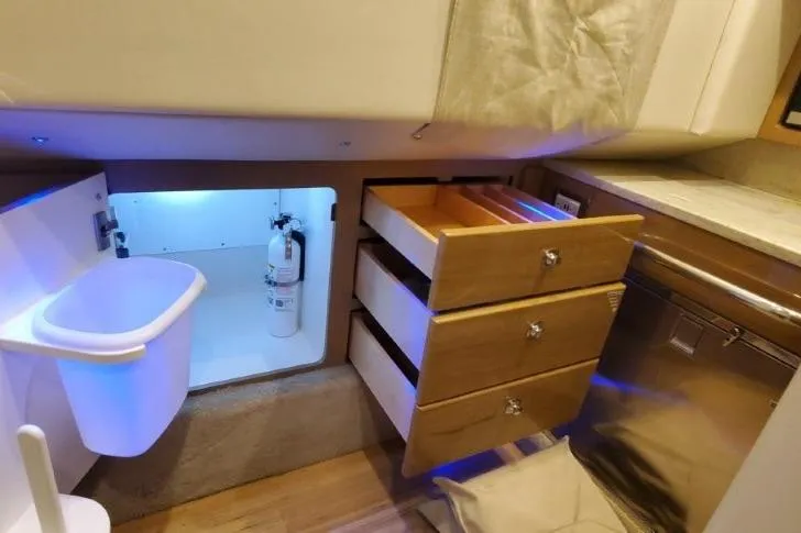 Slide: The Image of 2017 Formula 350 Crossover Bowrider interior with drawers, storage, and modern amenities. - 44