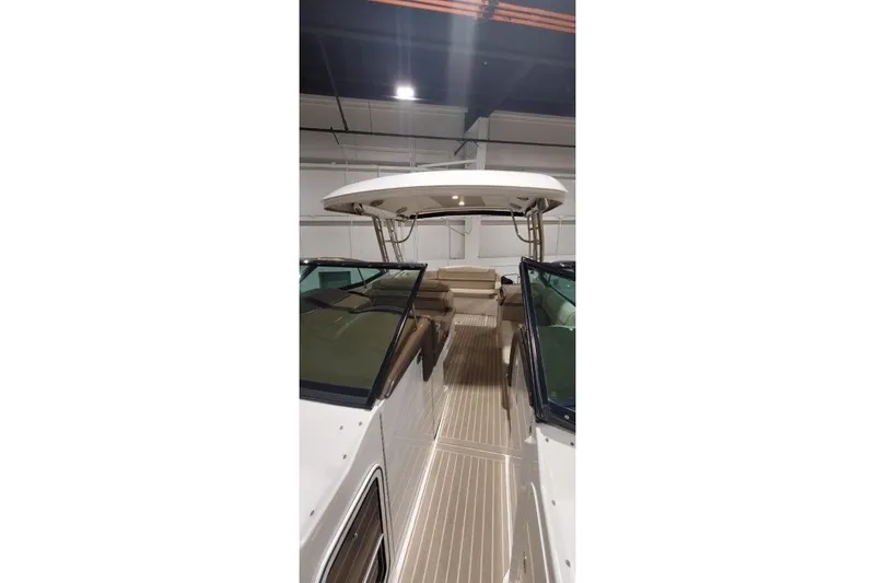 Slide: The Image of 2017 Formula 350 Crossover Bowrider interior with seating and canopy in a showroom. - 50