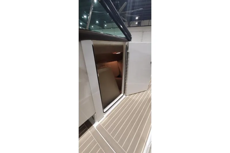 Slide: The Image of 2017 Formula 350 Crossover Bowrider cabin entrance with open door, showcasing interior. - 54