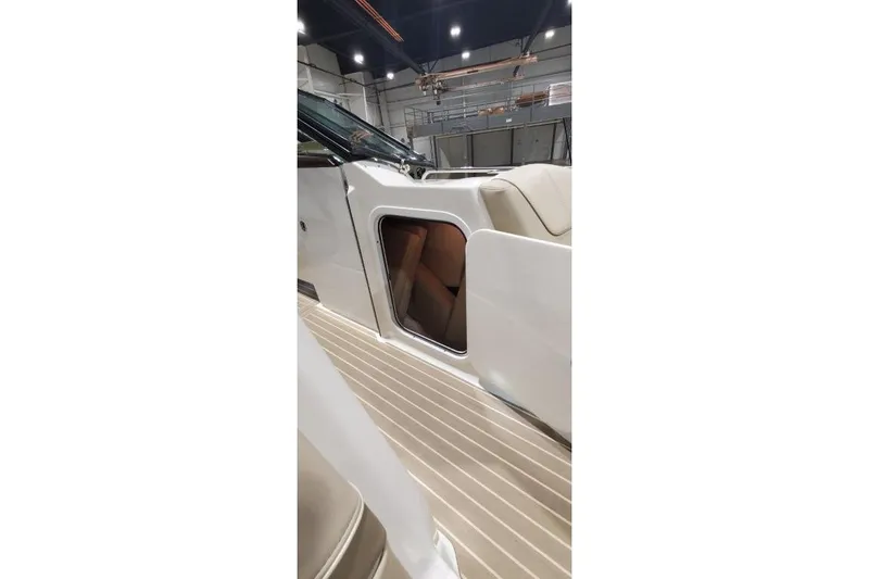 Slide: The Image of 2017 Formula 350 Crossover Bowrider interior with open storage compartment in a well-lit showroom. - 57