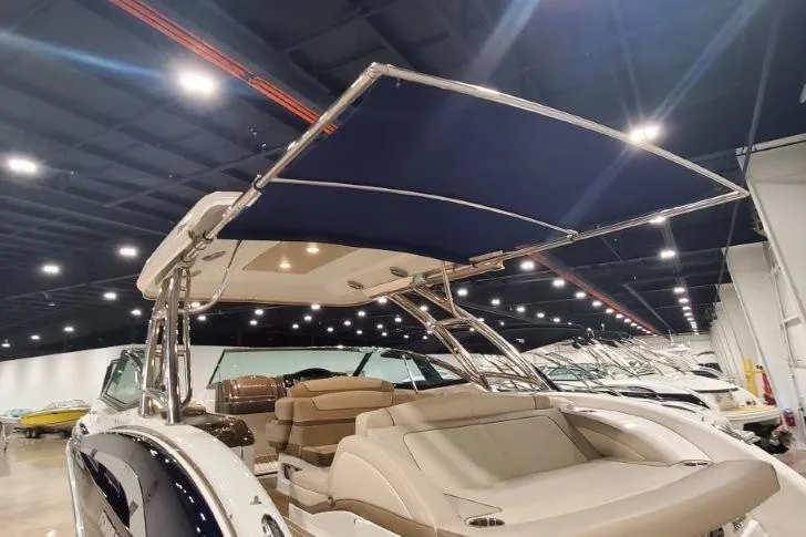Slide: The Image of 2017 Formula 350 Crossover Bowrider with canopy in a showroom setting. - 61