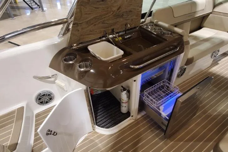 Slide: The Image of 2017 Formula 350 Crossover Bowrider interior with kitchenette, sink, and storage compartments. - 66