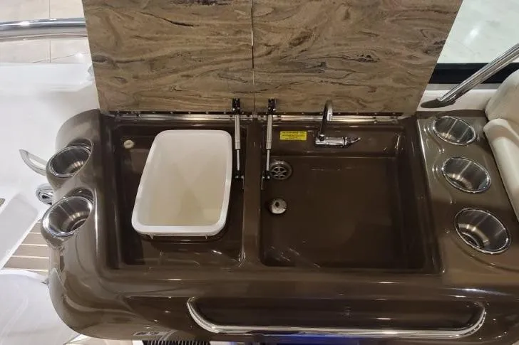 Slide: The Image of 2017 Formula 350 Crossover Bowrider sink area with cup holders and marble backsplash. - 67