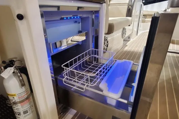 Slide: The Image of 2017 Formula 350 Crossover Bowrider interior with open drawer and fire extinguisher. - 68