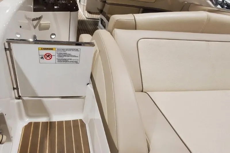 Slide: The Image of 2017 Formula 350 Crossover Bowrider interior with beige seating and wood flooring. - 77