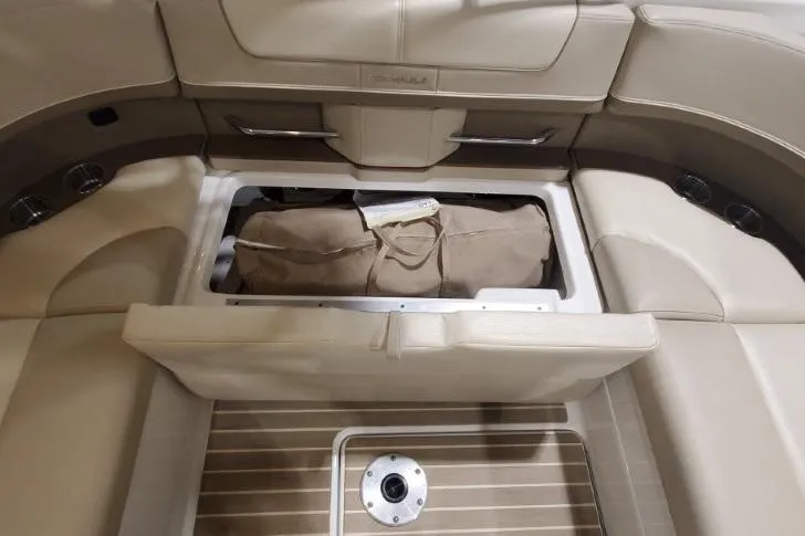 Slide: The Image of 2017 Formula 350 Crossover Bowrider interior storage compartment with beige seating and wooden flooring. - 79