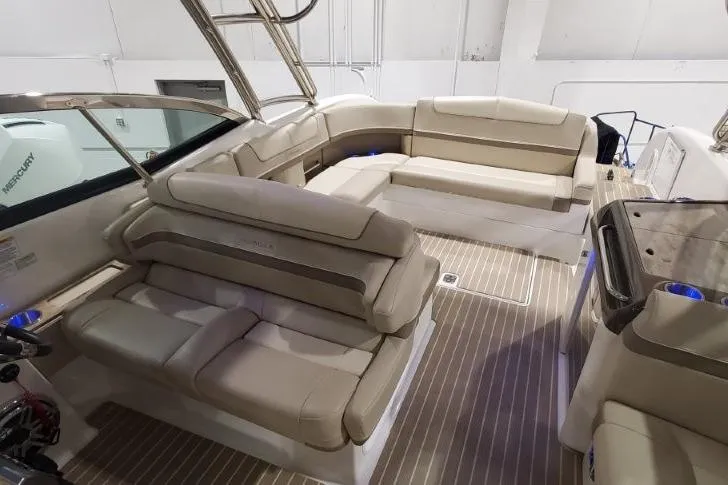 Slide: The Image of 2017 Formula 350 Crossover Bowrider interior with beige seating and wood flooring. - 83