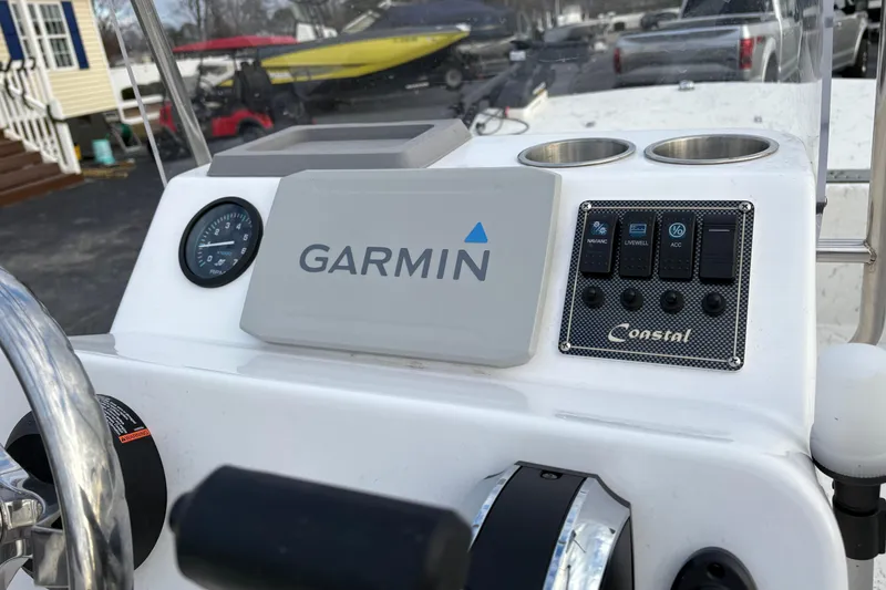 Slide: The Image of 2024 Coastal Skiff 171 dashboard featuring Garmin navigation and control panel. - 8