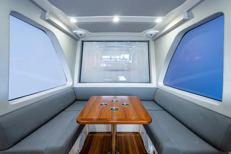 Slide: The Image of 2021 Gulf Crosser 52 interior with modern seating and wooden table. - 13