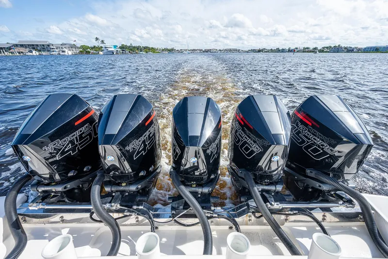 Slide: The Image of Four powerful outboard engines on a 2021 Gulf Crosser 52 boat cruising on water. - 15
