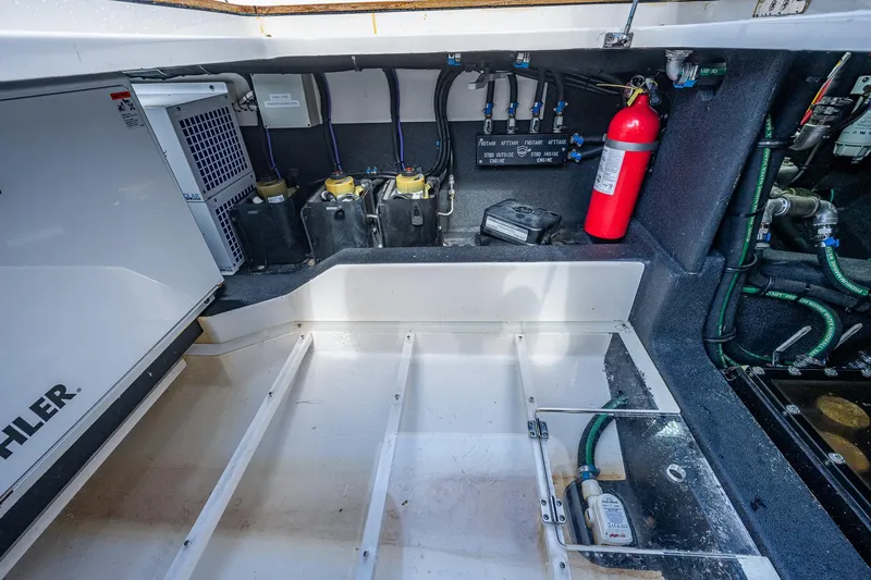 Slide: The Image of Engine compartment of a 2021 Gulf Crosser 52 boat with Kohler generator and fire extinguisher. - 17