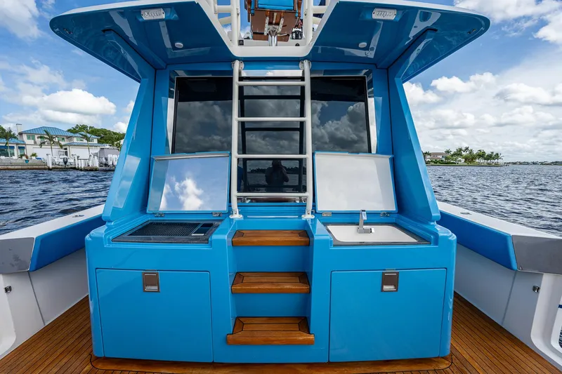 Slide: The Image of 2021 Gulf Crosser 52 yacht with blue exterior and onboard amenities. - 23