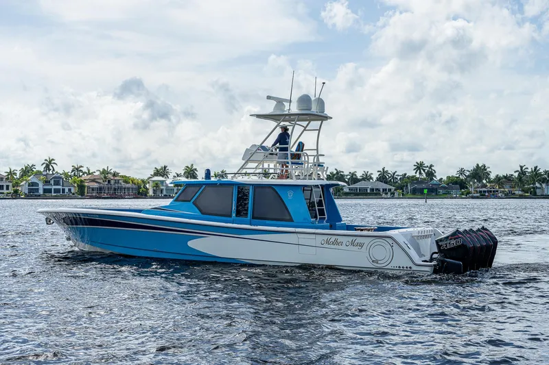 Slide: The Image of 2021 Gulf Crosser 52 boat cruising on a calm waterway with a scenic background. - 3