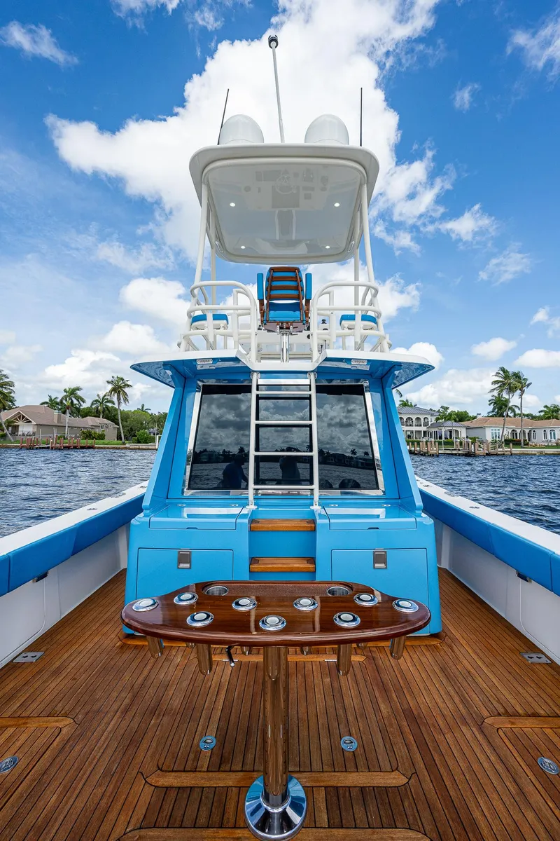 Slide: The Image of 2021 Gulf Crosser 52 yacht with blue accents and wooden deck on the water. - 30