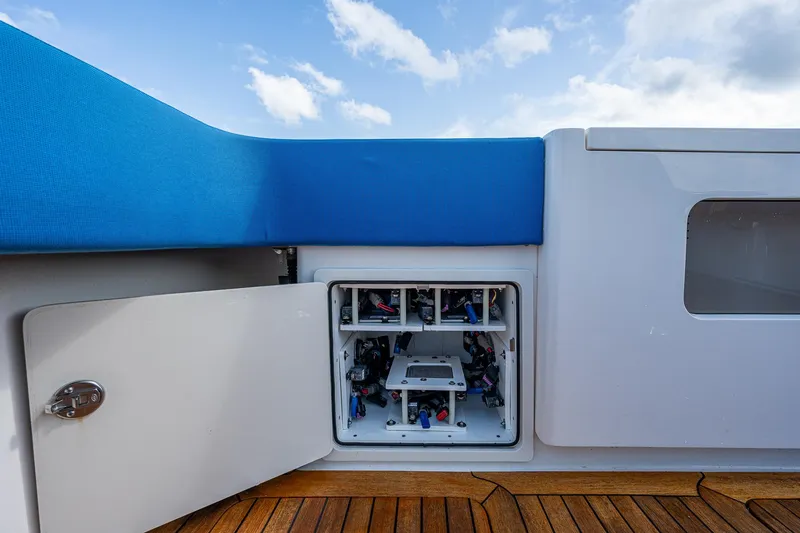 Slide: The Image of Gulf Crosser 52 (2021) yacht with open storage compartment and blue cushioned seating. - 33