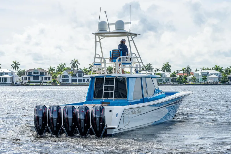 Slide: The Image of 2021 Gulf Crosser 52 boat with multiple outboard engines cruising on water. - 34