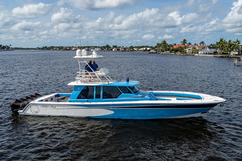 Slide: The Image of 2021 Gulf Crosser 52 boat cruising on a calm waterway under a partly cloudy sky. - 39