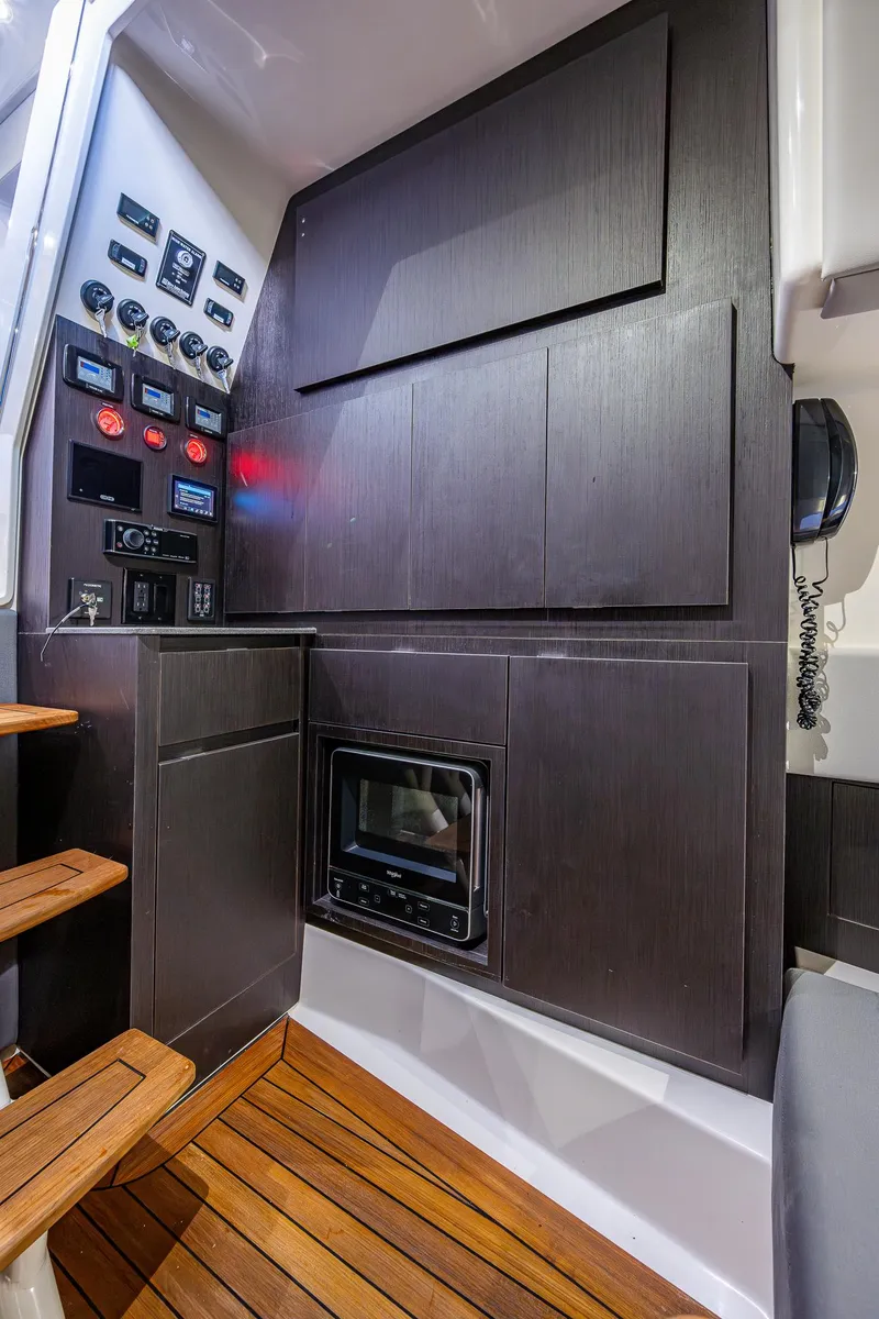Slide: The Image of 2021 Gulf Crosser 52 yacht interior with control panel and wooden flooring. - 44